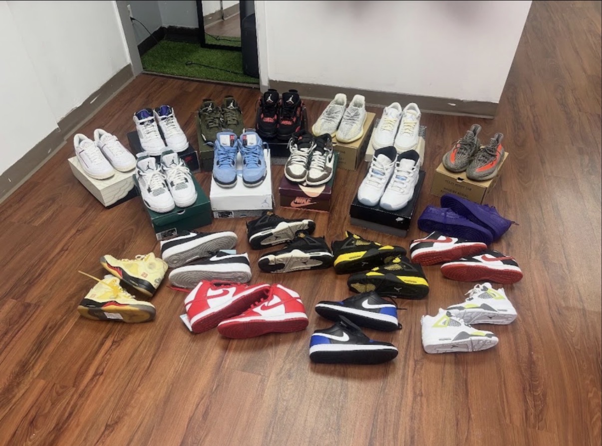 Fresh Jordan and Nike pairs laid out on the floor at Gravity Sneakers