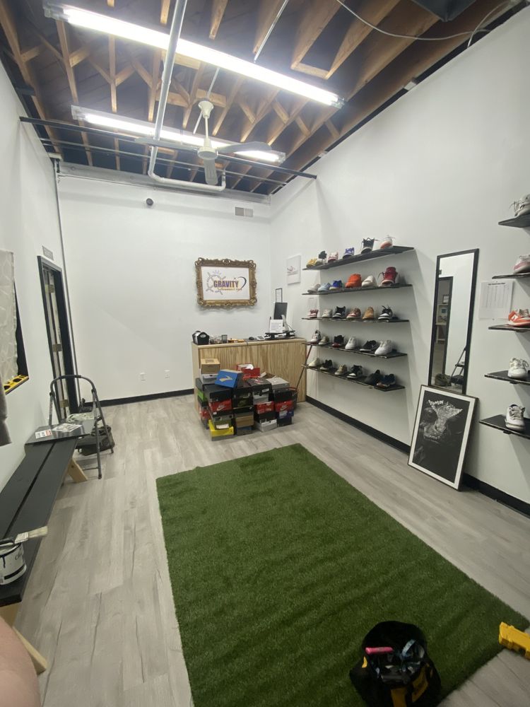 Inside Gravity Sneakers — shoe shelves, turf rug, and the counter at the Farmington shop