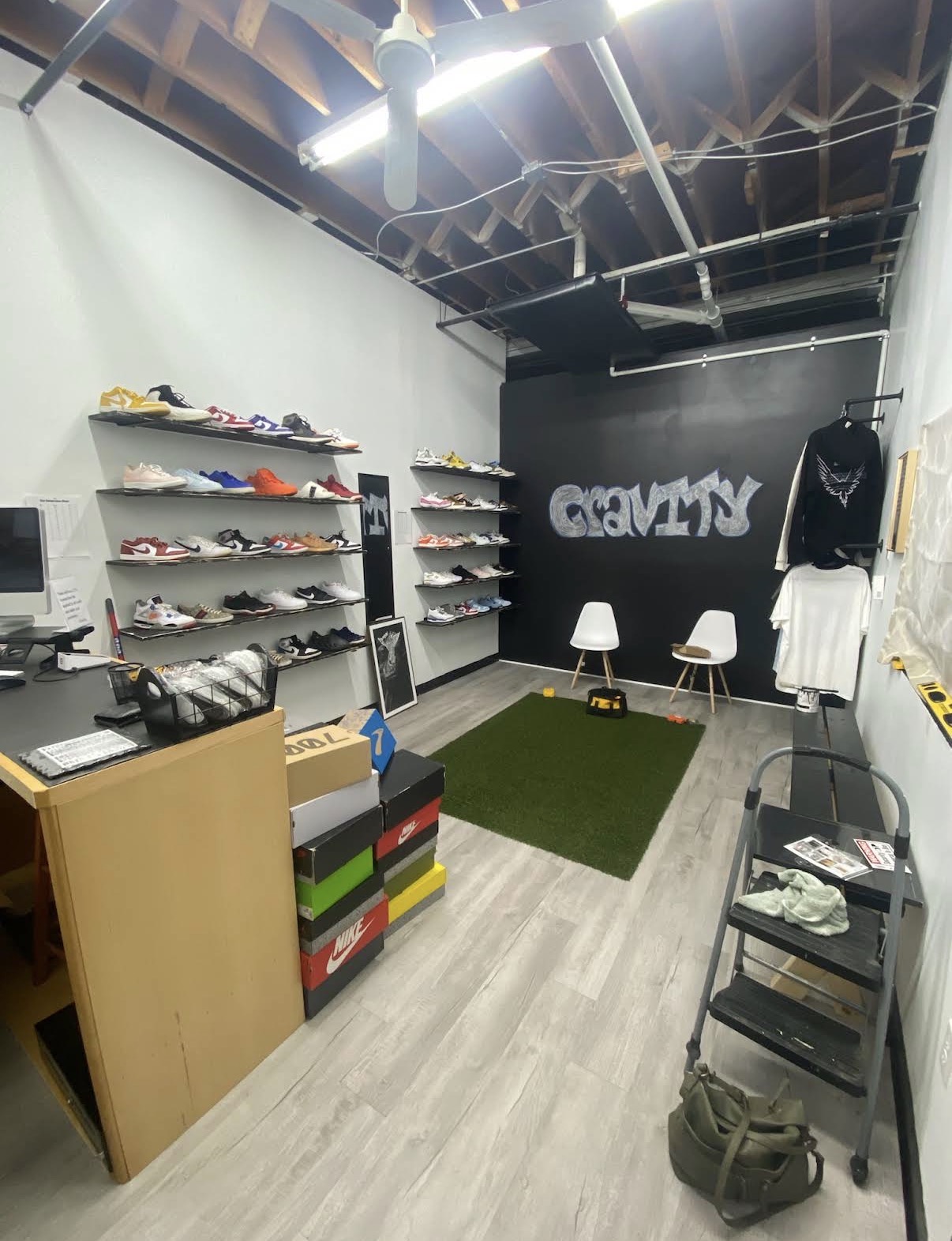 Inside Gravity Sneakers — sneaker shelves, turf rug, and the Gravity graffiti wall